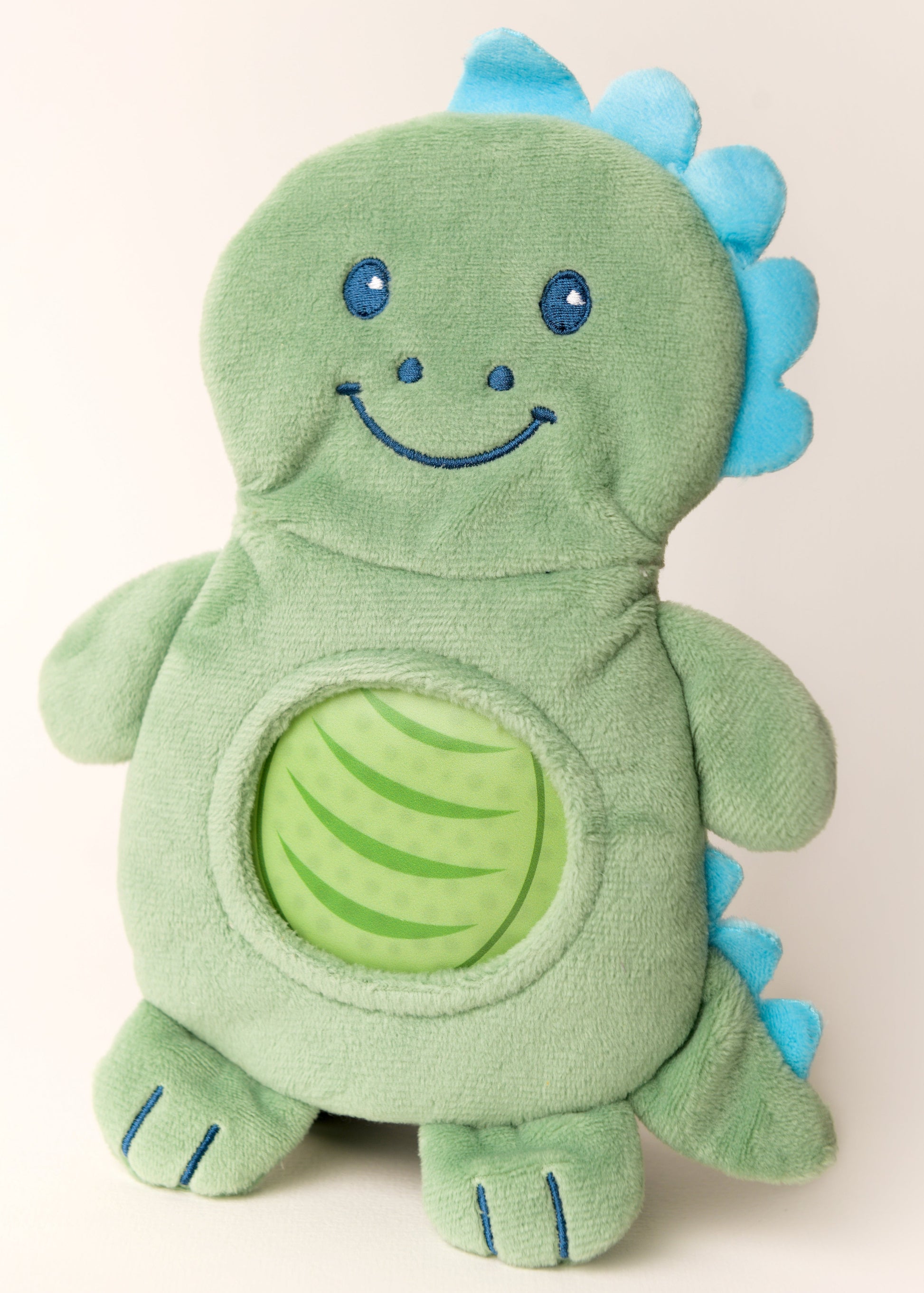 Green plush dinosaur toy with blue accents on a white background